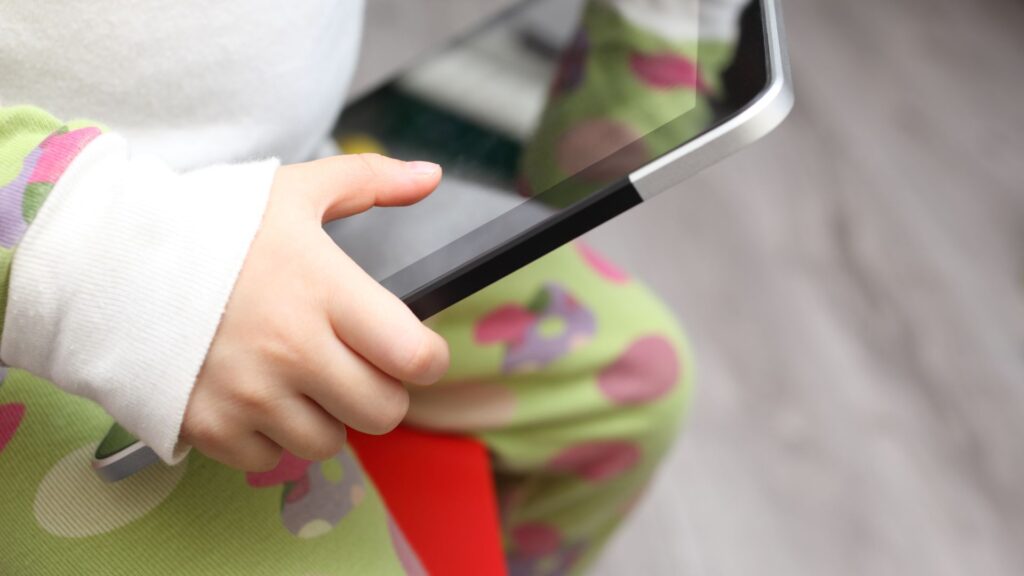 Toddler holding an iPad