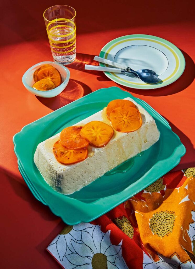 Plate of persimmon panna cotta on a table with orange tablecloth