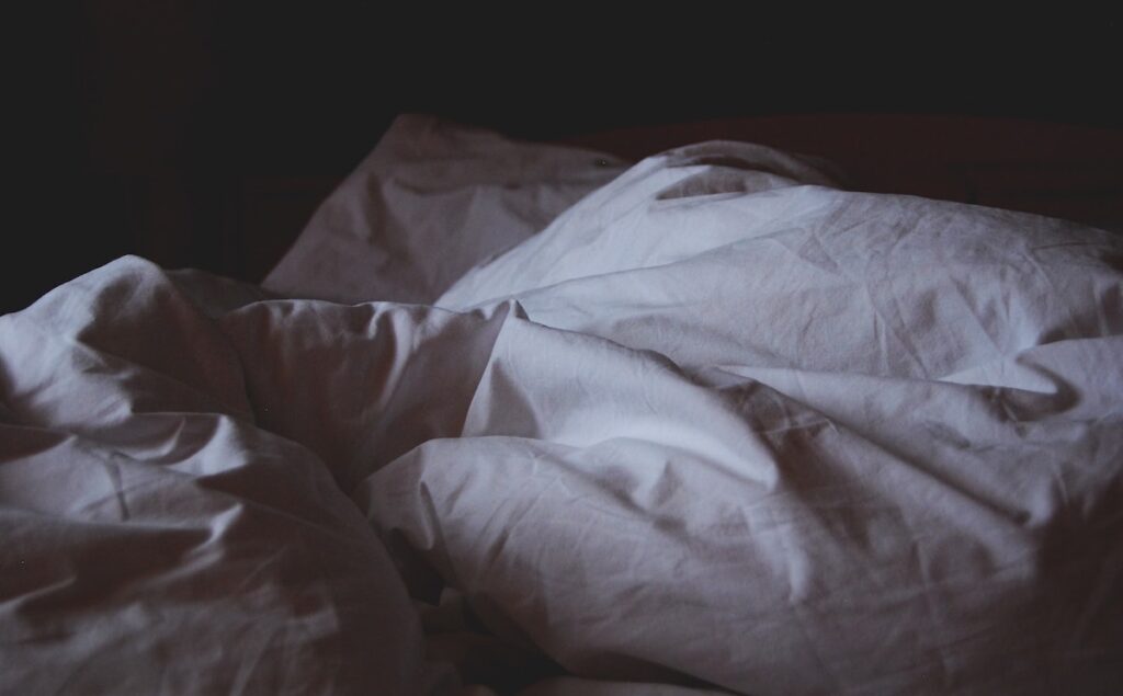 Night shot of a rumpled bed